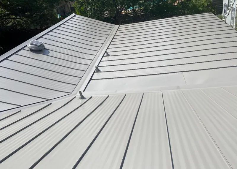 Solar attic fan installed on a metal roof for Roof Ventilation in Detroit